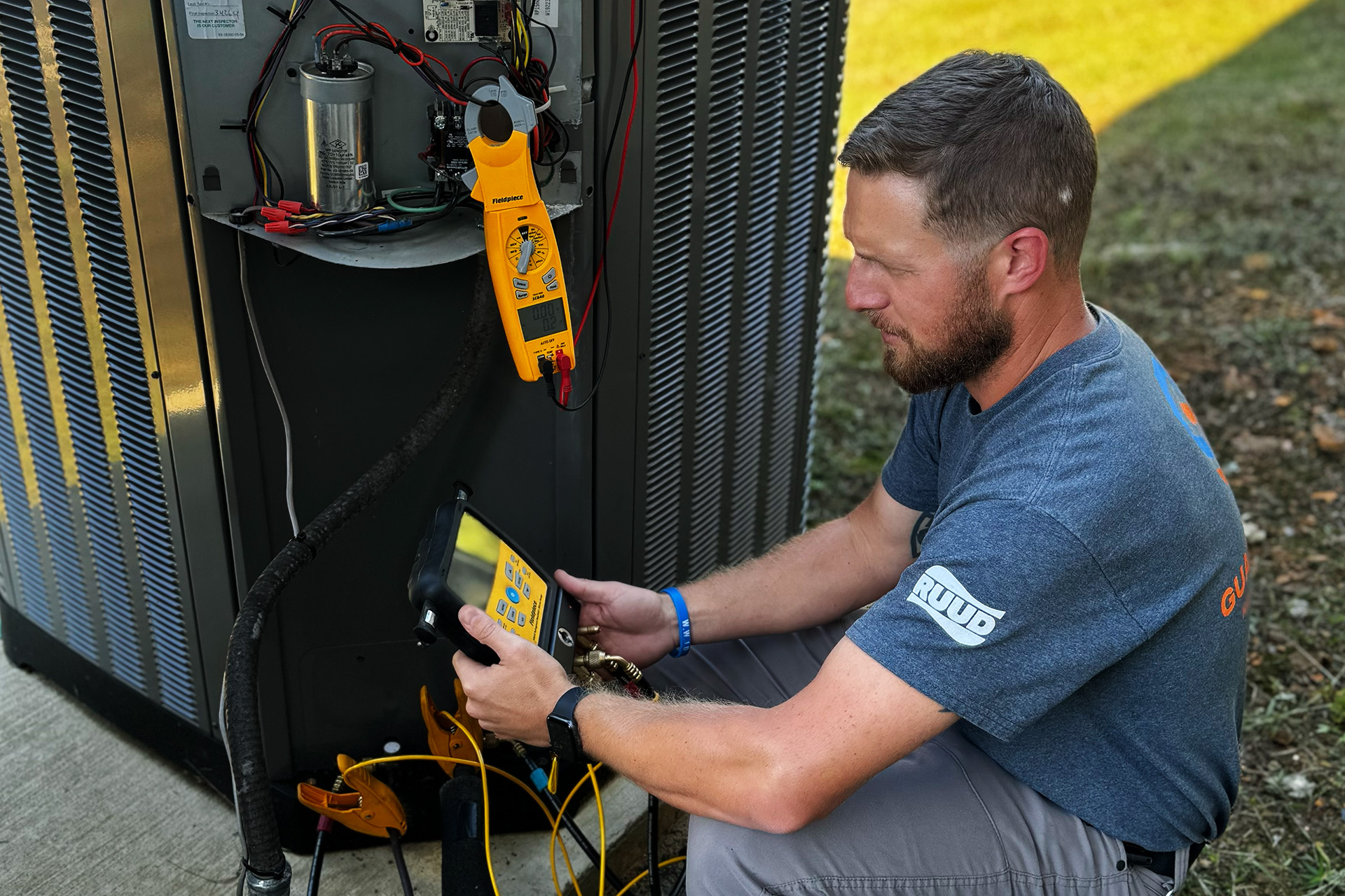 Guardian Air technicians using Fieldpiece meters to check HVAC unit during routine maintenance